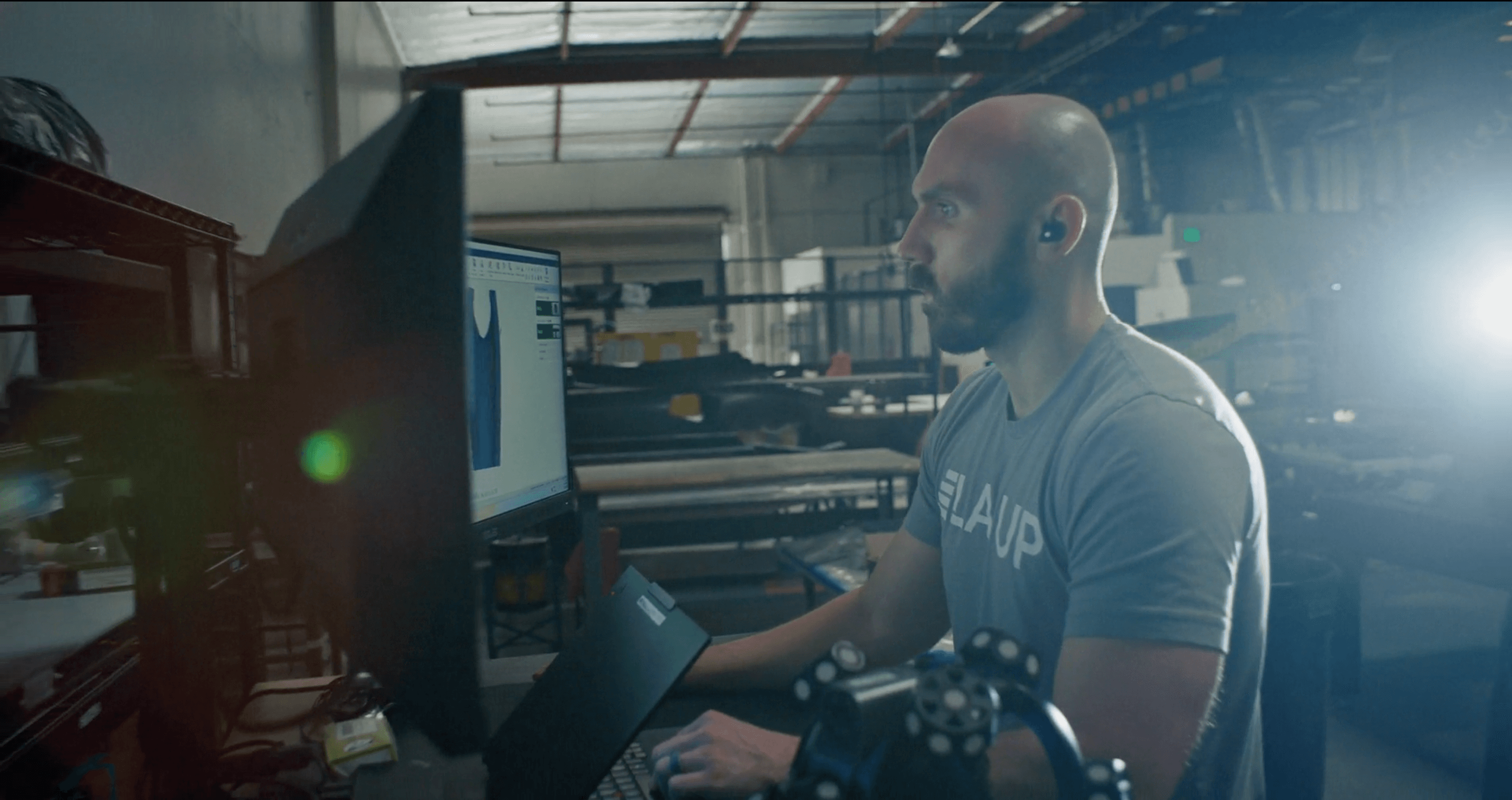 Technician working at a computer station in the Layup workshop